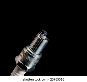 An Igniting Spark Plug On A Black Background