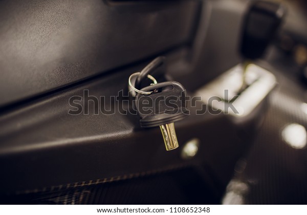 Ignition\
key modern car close up. Car atv key in\
keyhole