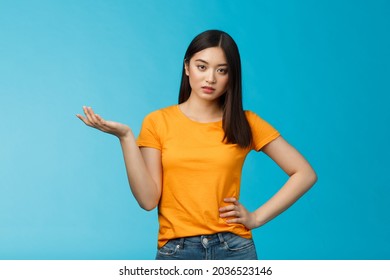 Ignorant bossy asian woman high-standarts, look dismay arrogant, act snobbish complaining bad service, raise hand full disbelief, cannot stand nonsense, stand annoyed blue background