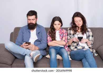 Ignored Child. Busy Parents Surfing Internet Smartphones. Dad And Mom Ignoring Daughter Needs. Bad Habits. Parenthood Failure. Ignored Baby. Offended Feelings. Stop Ignoring Kid. Stuck In Online