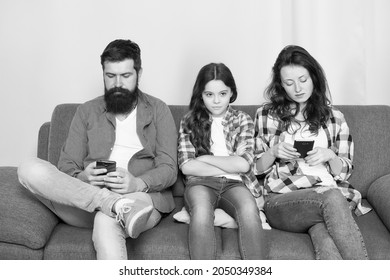 Ignored Child. Busy Parents Surfing Internet Smartphones. Dad And Mom Ignoring Daughter Needs. Bad Habits. Parenthood Failure. Ignored Baby. Offended Feelings. Stop Ignoring Kid. Stuck In Online