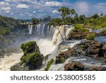 Iguazu falls, Cataratas del Iguazu waterfall in Brazil and Argentina. Huge powerful water stream in the tropical jungle forest of South America on river Iguasu