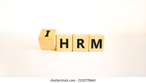 IHRM, International Human Resource Management HRM Symbol. Words IHRM, International Human Resource Management On Cubes On A White Background. Businessman Hand. Business, IHRM HRM Concept. Copy Space.