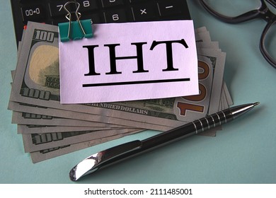 IHT (Inheritance Tax) - Acronym On A White Piece Of Paper Fixed On Banknotes Against The Background Of A Calculator, Glasses And Pen. Business And Finance Concept