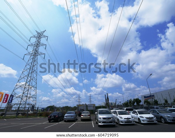 IKEA\'s car park overlooks the blue sky,\
high voltage pole March 18, 2016 Bangna,\
Thailand.