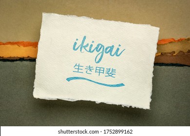 ikigai - Japanese philosophy and life style  - a reason for being or a reason to wake up  - handwriting on a handmade rag paper against abstract landscape
