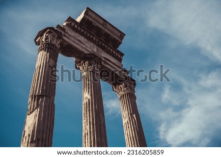 Il Tempio dei Dioscuri collumns on the blue sky. Rome. Italy.