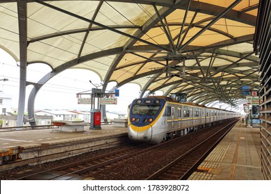 Ilan County , Taiwan : Jan 15th ,2018 : Taroko Express Train Is Coming Pass Dong Shan Train Station With The Shed For The Melon Style