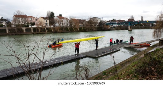 ILE-DE-FRANCE, FRANCE - JANUARY 26, 2019: Junior Rowers Training At Marne River. Boys Carrying And Getting The Boat In The Water.