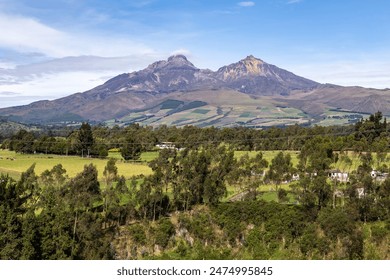 Ilinizas Volcano, Andean landscape with its crop fields and mountains showing their greenery on a clear morning