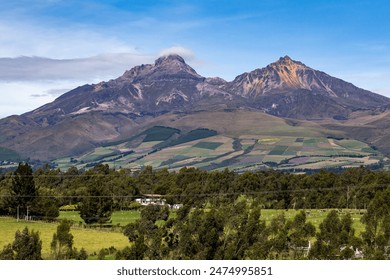 Ilinizas Volcano, Andean landscape with its crop fields and mountains showing their greenery on a clear morning