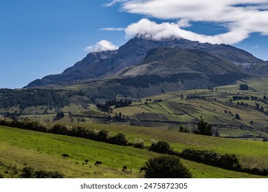 Ilinizas Volcano, Andean landscape with its crop fields and mountains showing their greenery on a clear morning, south eastern view.