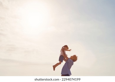 Ill always be here to catch you. Shot of a father lifting his daughter into the air at the beach.