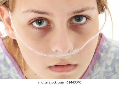 Ill American 16 Year Old Girl In Hospital Gown With Oxygen Tube Over White Background.