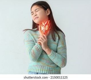 Ill Asian Girl With Pain In Throat On Light Background