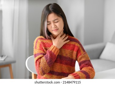 Ill Asian Girl With Sore Throat At Home