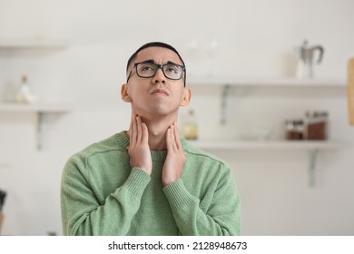 Ill Asian Man With Sore Throat At Home