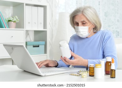 Ill Beautiful Senior Woman  With Facial Mask Using Laptop