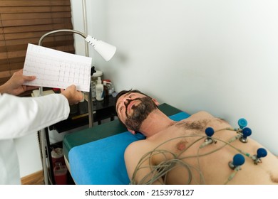 Ill Latin Man Getting His Heart Rate Monitored With An Electrocardiogram Equipment At The Cardiologist Office