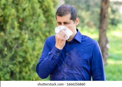 Ill Man Blowing Using A Tissue In A Park