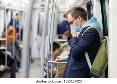 Ill man in glasses feeling sick  coughing  wearing protective mask against transmissible infectious diseases   as protection against the flu in public transport  New coronavirus 2019  nCoV from China