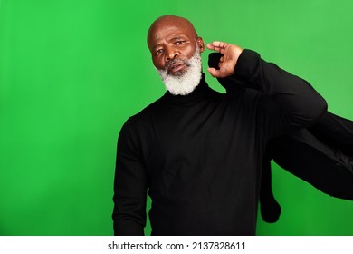 Ill Never Grow Tired Of Dressing Up. Studio Shot Of A Senior Man Posing Against A Green Background.