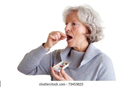 Ill Old Woman Taking A Pill From A Pill Dispenser