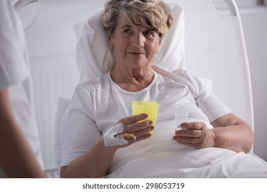 Ill Older Woman At Hospital Taking Pills