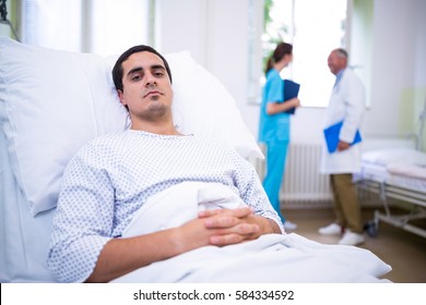 Ill Patient Lying On Bed In Hospital