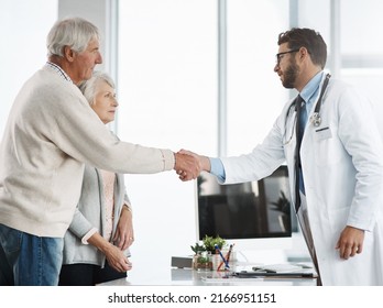 Ill See You Again Next Week. Cropped Shot Of A Confident Young Male Doctor Shaking A Senior Patients Hand After A Consultation.