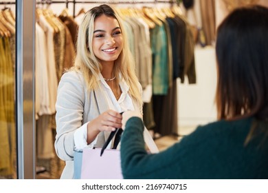 Ill See You Next Time. Shot Of A Young Woman Helping A Customer In A Clothing Boutique.