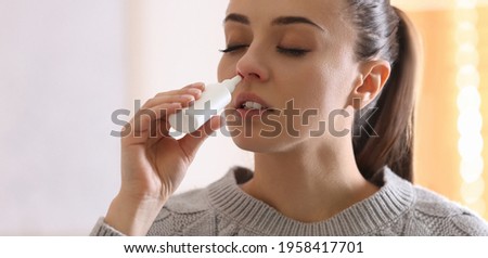 Ill woman using nasal spray at home Сток-фото © 