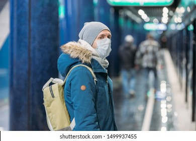 Ill Young Man Feeling Sick, Wearing Protective Mask Against Transmissible Infectious Diseases And As Protection Against The Flu In Public And Transportation.