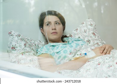 Ill Young Woman Lying In Hospital Bed