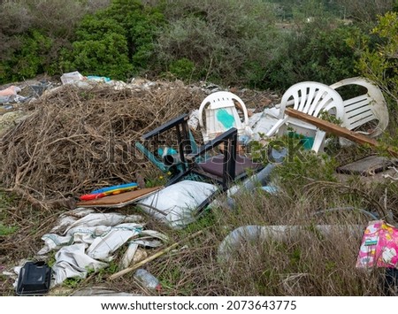 Illegal dumping of garbage causing environmental damage to the countryside.