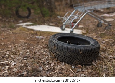 Illegal dumping of tyres and other stuff in the countryside. The concept of environmental pollution. - Shutterstock ID 2184835407