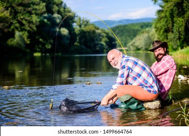 Illegal Hunting Caviar. Extracts Eggs From Sturgeon Caught River. Trap For Fish. Men Sit At Riverside With Fishing Equipment. Poaching Crime And Fishing License. Poachers Fishing. Black Market Caviar.