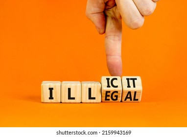 Illegal or illicit symbol. Businessman turns wooden cubes and changes the concept word Illegal to Illicit. Beautiful orange table and background. Business and illegal or illicit concept. Copy space.
