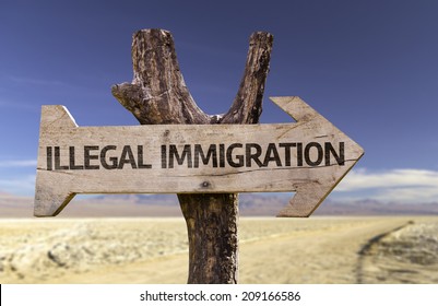 Illegal Immigration wooden sign with a desert background