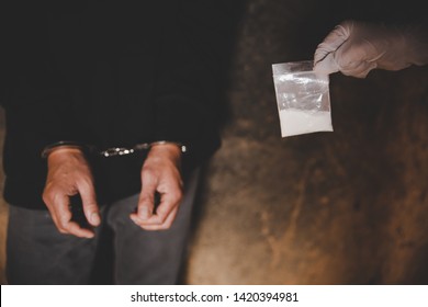 Illegal Transport Of Drugs. A Police Officer Finds Drugs During The Search Of Drug Dealers. Law And Police Concept.