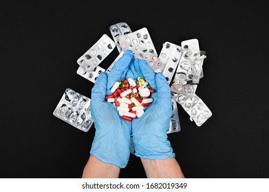 Illegal Use Of The Pharmaceutical Industry.Concept Of Medication Abuse. Colored Pills On Black Table.