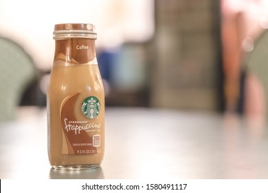 Illinois, Rockford, USA - Oct 2019: Starbucks Frappuccino Bottle On A Wooden Table. Frappuccino Is A Line Of Iced Coffee Drink