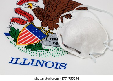 Illinois State Flag And N95 Face Mask. Concept Of State And Local Government Face Covering Mandate, Order, Requirement And Social Distancing During Covid-19 Coronavirus Pandemic