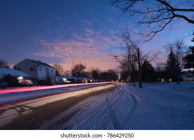 Illinois Suburbs Covered In Snow On A Winter Night And Street With Cars Passing By, Long Exposure Car Light Trails, America