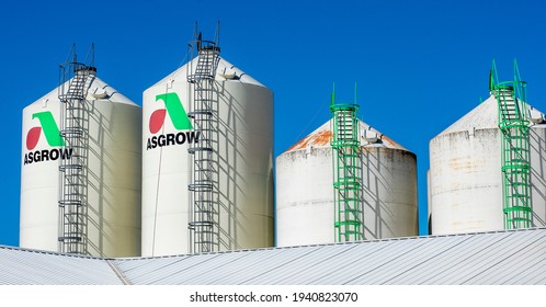 Illinois, USA, October 2021 - Metal silos containing Asgrow soybean seeds at elevator grain business in farm country. Monsanto, chemically altered, GMO, genetically engineered seeds, bins, farming