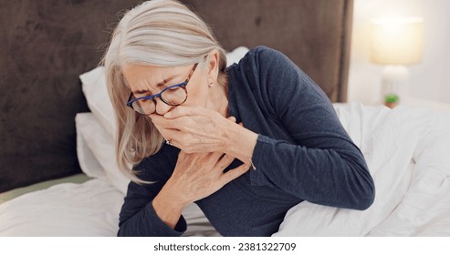 Illness, cough and senior woman in bed with allergies, flu or cold on a weekend morning at home. Sick, chest pain and elderly female person in retirement with asthma or infection in bedroom at house. - Powered by Shutterstock