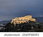 Illuminated Acropolis of Athens with Parthenon at Night Under Dramatic Sky