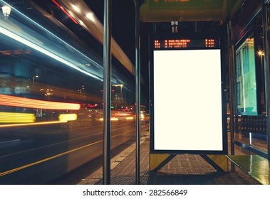 Illuminated blank billboard with copy space for your text message or content, advertising mock up banner of bus station, public information board with blurred vehicles in high speed in night city  - Shutterstock ID 282566849