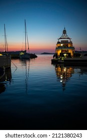 Illuminated boats at dusk at the Greek village of Naousa, Paros island, Cyclades