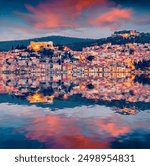 Illuminated buildings of Sibenik port reflected in the calm waters of Adriatic sea. Spectacular summer sunset in resort of Croatia . Beautiful world of Mediterranean countries. Travel the world.